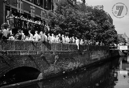 GayFest 2001: people sitting on the wall along Canal Street